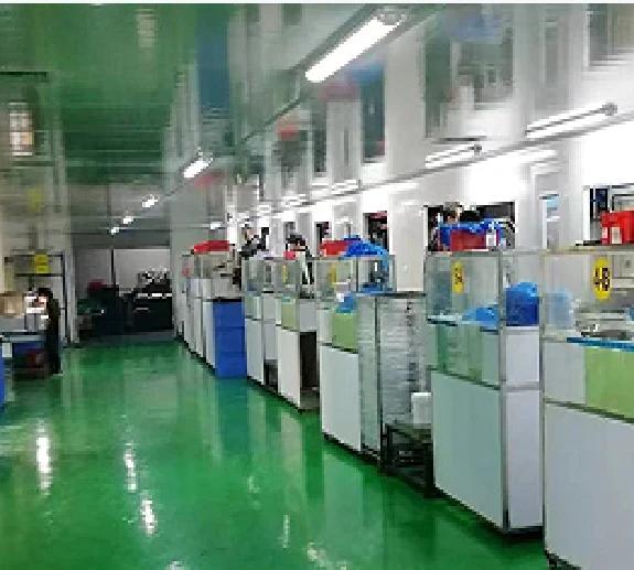Production hall with rows of moulding machines along a green epoxy floor