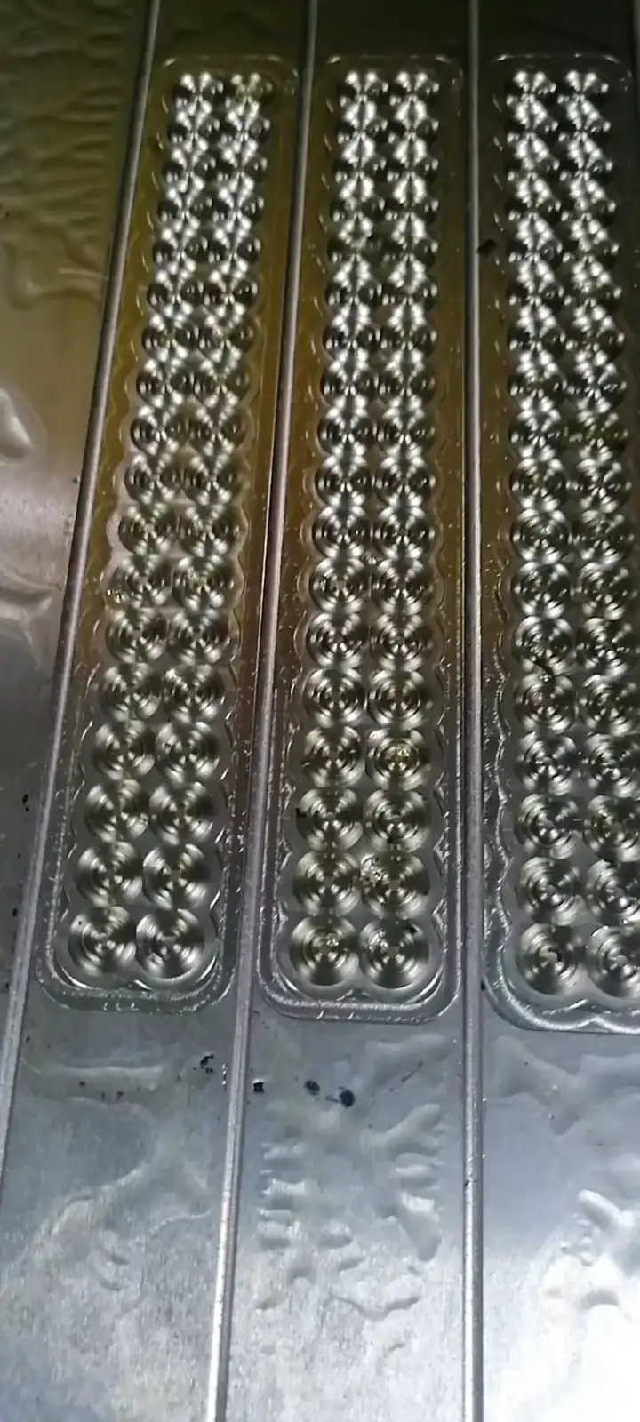 Long steel O-ring mould strips with rows of machined ring cavities