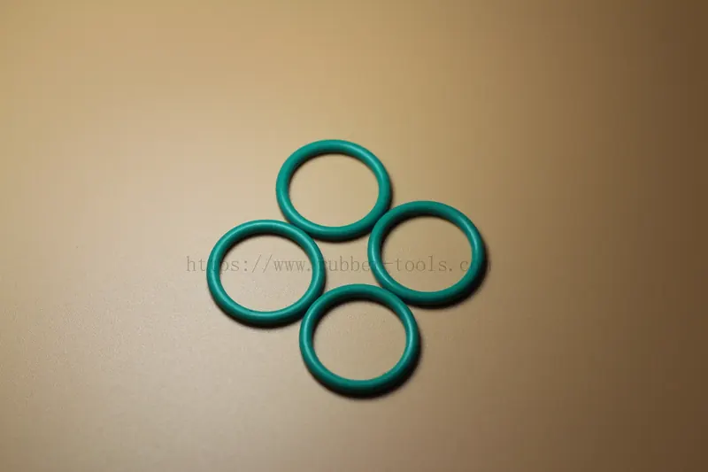 Four teal fluoroelastomer O-rings arranged in a cluster
