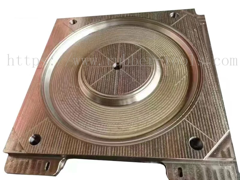 Machined steel mould plate with a circular central cavity and guide pins