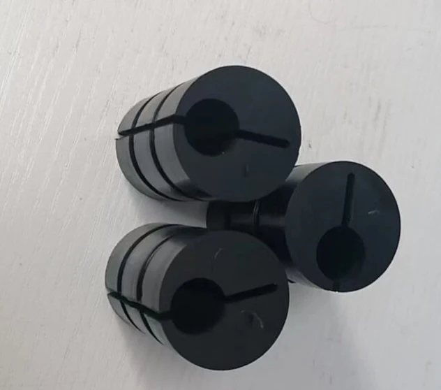Three black moulded SBR rubber counterweight blocks with tapered profiles