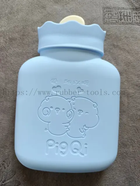 Blue moulded silicone hot water bag with embossed bear pattern and screw cap