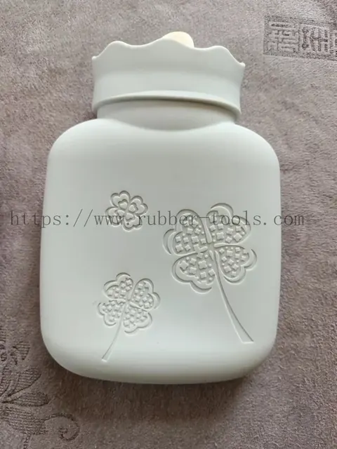 Pale green moulded silicone hot water bag with embossed bear pattern