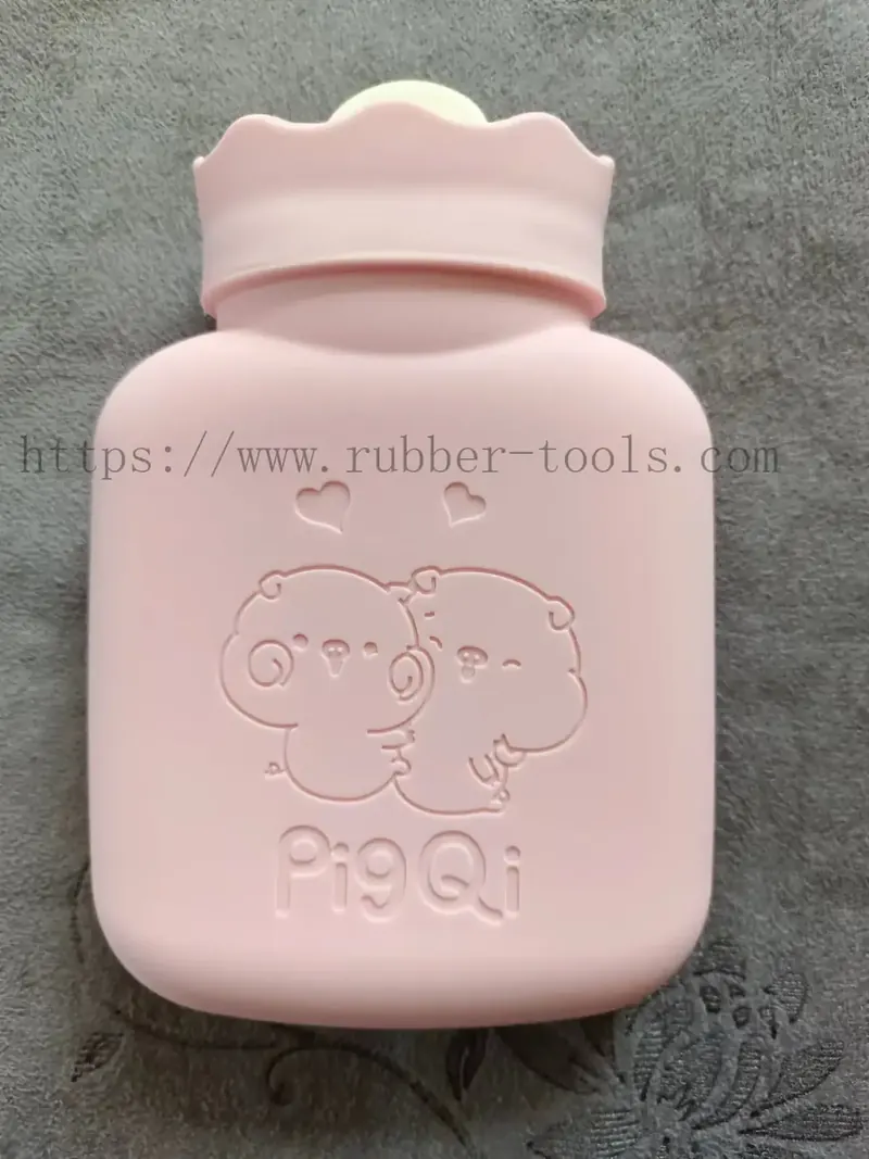 Pink moulded silicone hot water bag with embossed bear pattern and screw cap