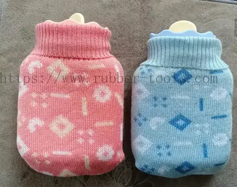 Two silicone hot water bags in knitted woolen covers in pink and blue